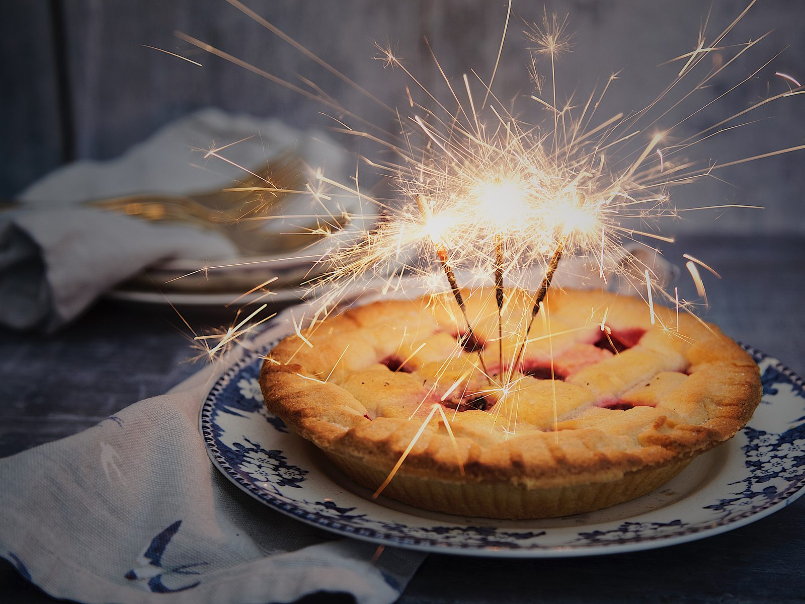 Torta de cereja com massa dourada e estrelinhas acesas