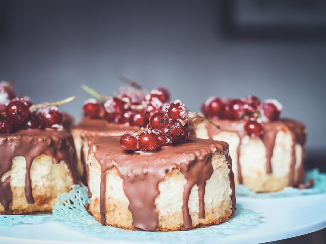 Mini bolos com cobertura de chocolate e groselhas vermelhas